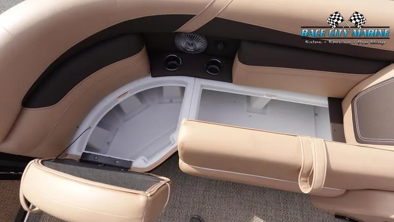 Slide: The Image of 2025 Barletta Cabrio 22QC boat interior with open storage compartment and beige seating. - 45