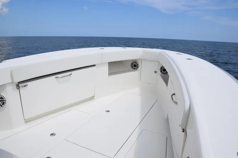 Slide: The Image of 2020 SeaVee 370z boat interior with ocean view, featuring sleek white design and storage compartments. - 17
