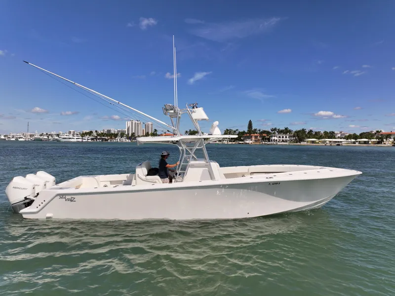 Slide: The Image of 2020 SeaVee 370z boat on calm water under a blue sky with clouds. - 2