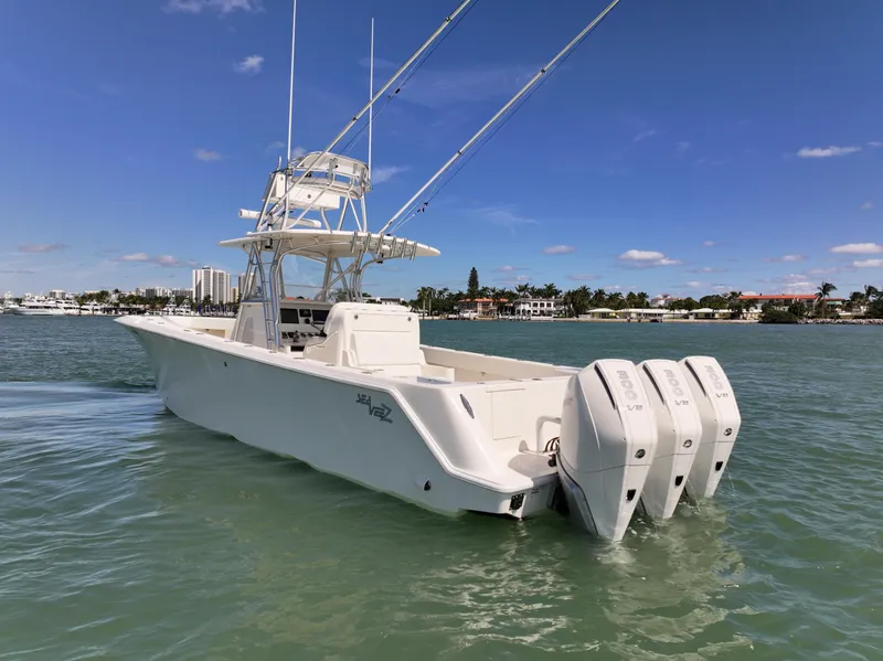 Slide: The Image of 2020 SeaVee 370z boat with triple outboard engines on calm water. - 7