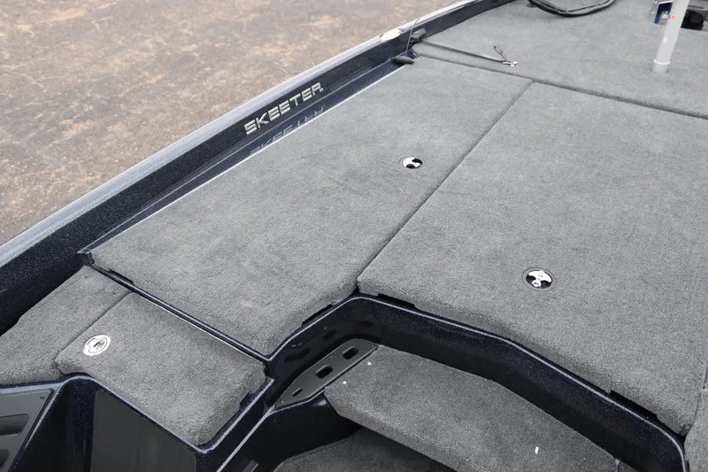 Slide: The Image of 2025 Skeeter ZXR 21 boat deck with gray carpet and storage compartments. - 14
