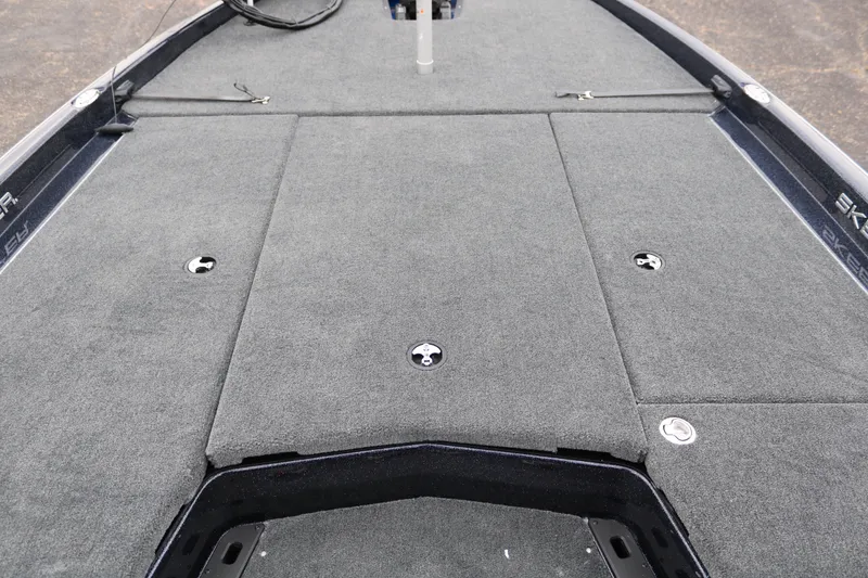 Slide: The Image of 2025 Skeeter ZXR 21 boat deck with gray carpet and storage compartments. - 16