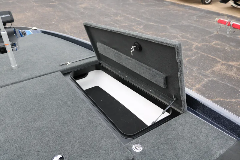 Slide: The Image of 2025 Skeeter ZXR 21 boat storage compartment with open lid, showcasing interior space. - 19