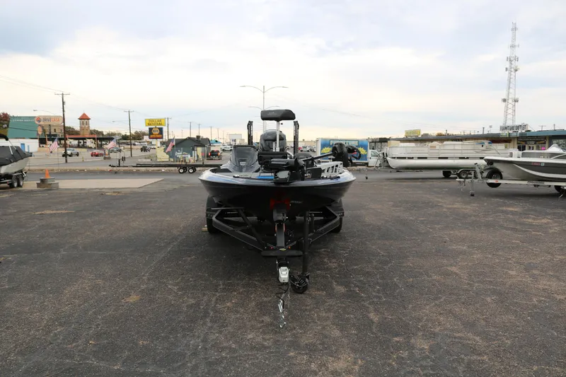 Slide: The Image of 2025 Skeeter ZXR 21 boat on trailer in parking lot. - 2