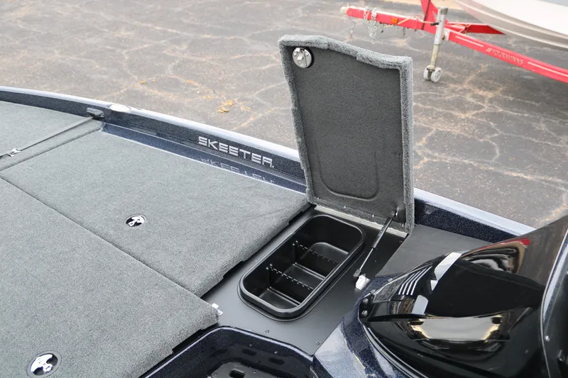 Slide: The Image of 2025 Skeeter ZXR 21 boat deck with open storage compartment. - 21