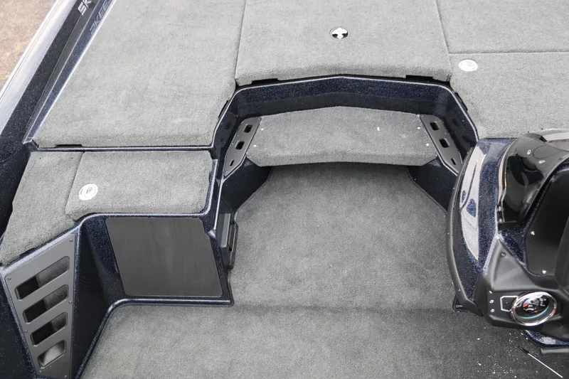 Slide: The Image of 2025 Skeeter ZXR 21 boat interior with carpeted deck and storage compartments. - 22