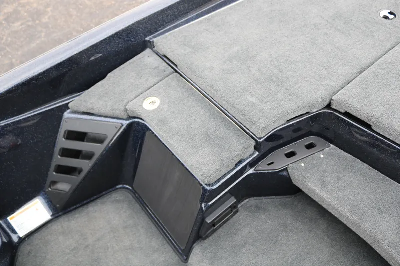 Slide: The Image of 2025 Skeeter ZXR 21 boat interior with carpeted storage compartments. - 24