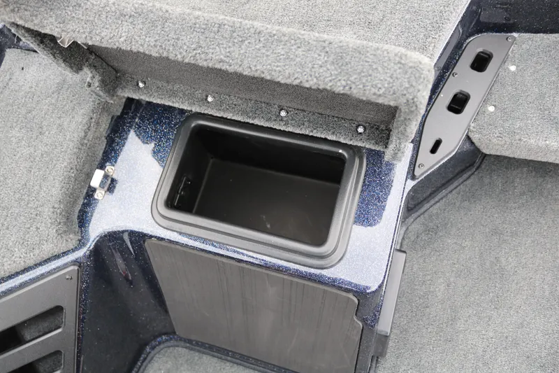 Slide: The Image of 2025 Skeeter ZXR 21 boat storage compartment with carpeted interior. - 25