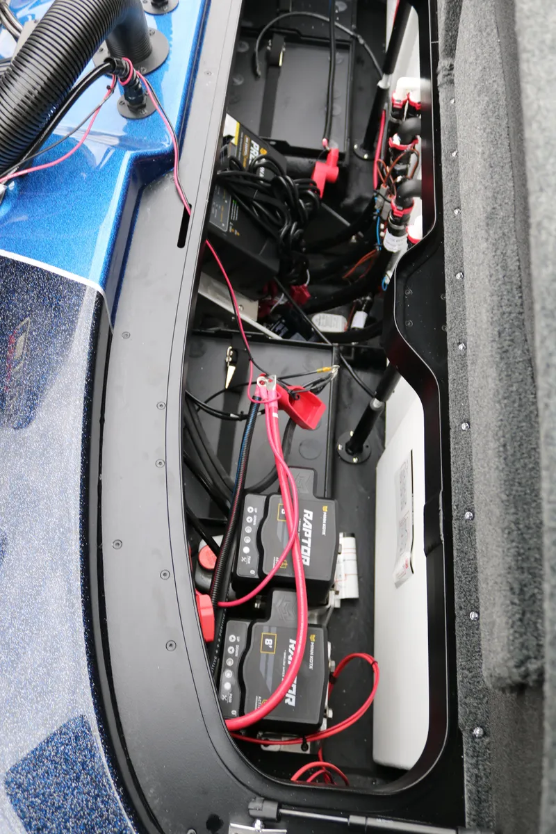 Slide: The Image of 2025 Skeeter ZXR 21 boat battery compartment with wiring and components. - 38
