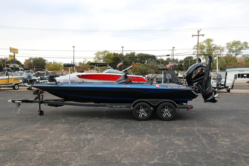 Slide: The Image of 2025 Skeeter ZXR 21 boat on trailer in parking lot. - 4