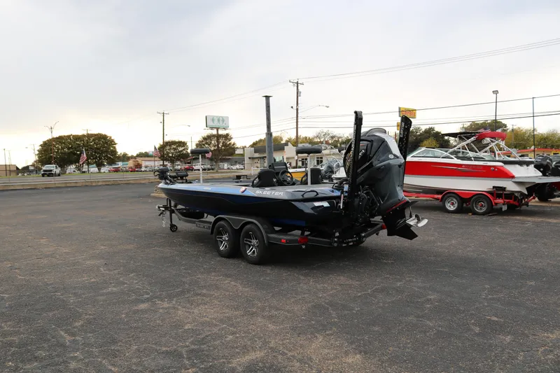 Slide: The Image of 2025 Skeeter ZXR 21 boat on trailer in parking lot, rear view. - 5