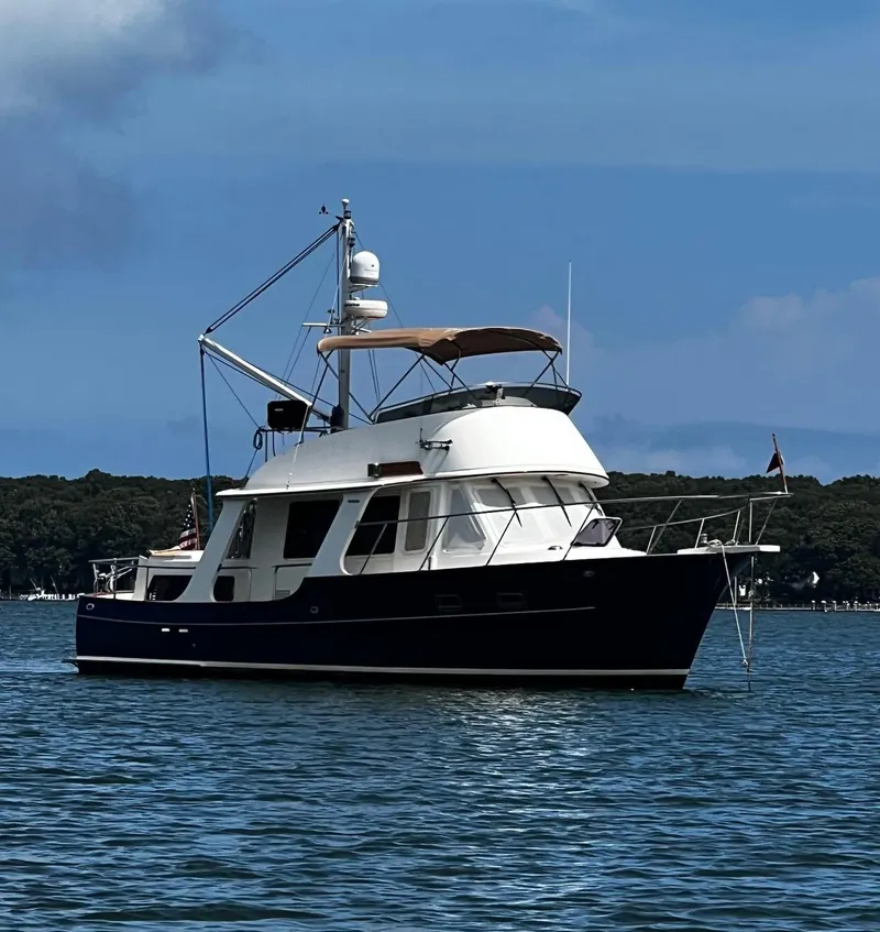 Slide: The Image of Pacific Seacraft 38T Fast Trawler 2000 on calm water, blue sky background. - 0