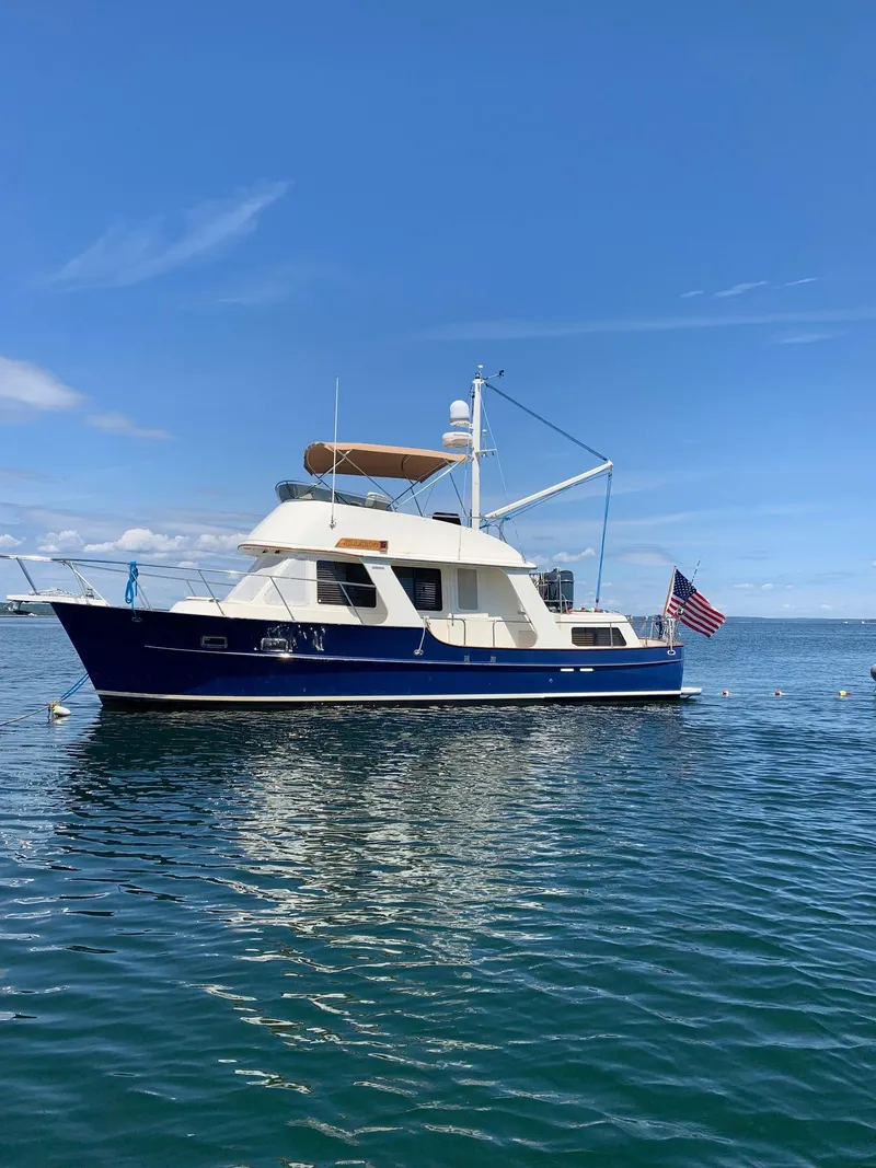 Slide: The Image of Pacific Seacraft 38T Fast Trawler 2000 on calm water, blue sky background. - 1