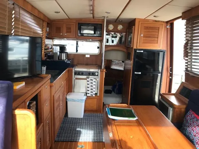 Slide: The Image of Interior of 2000 Pacific Seacraft 38T Fast Trawler with kitchen and dining area. - 13