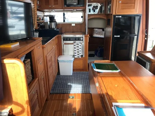 Slide: The Image of Interior of 2000 Pacific Seacraft 38T Fast Trawler with wooden cabinetry and modern appliances. - 14