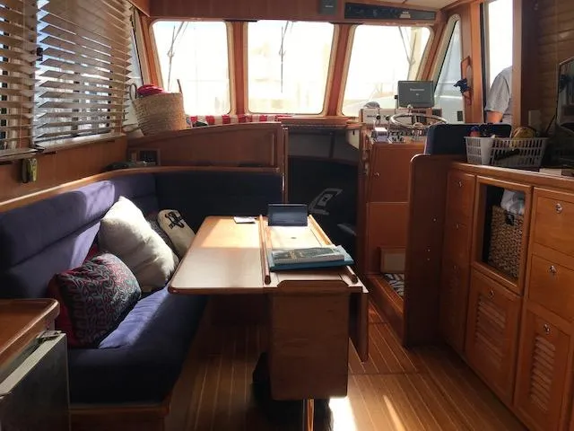 Slide: The Image of Interior of 2000 Pacific Seacraft 38T Fast Trawler with cozy seating and wooden finishes. - 15