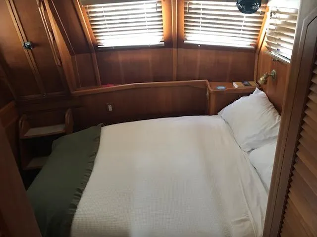 Slide: The Image of Cozy cabin bedroom in 2000 Pacific Seacraft 38T Fast Trawler with wooden interior. - 18