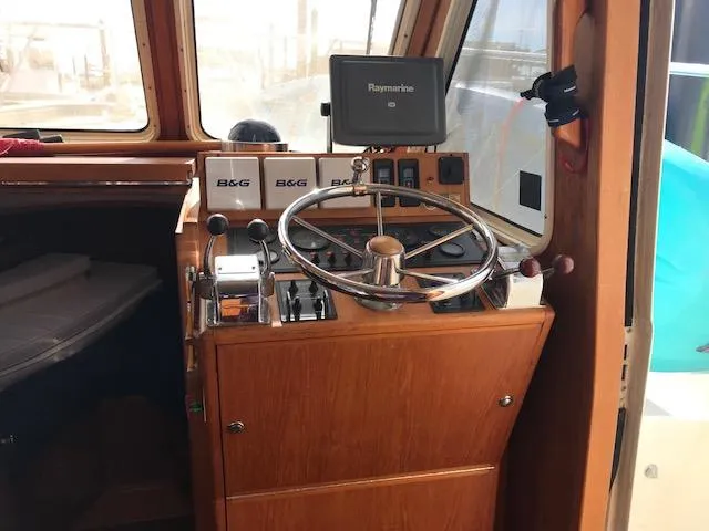 Slide: The Image of Helm of 2000 Pacific Seacraft 38T Fast Trawler with navigation equipment. - 24