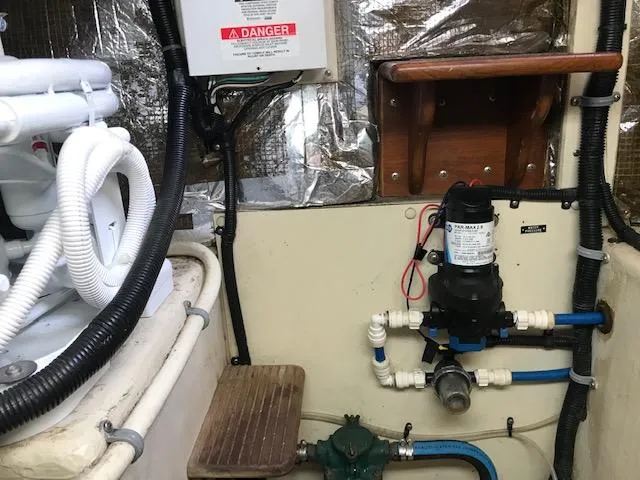 Slide: The Image of Engine room of 2000 Pacific Seacraft 38T Fast Trawler with plumbing and electrical components. - 27