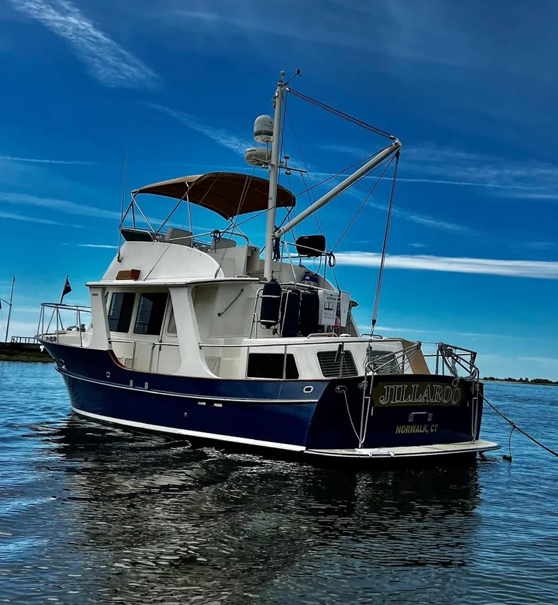 Slide: The Image of Pacific Seacraft 38T Fast Trawler 2000 on calm water under clear blue sky. - 34