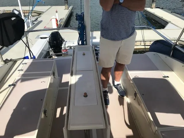 Slide: The Image of Man standing on deck of 2000 Pacific Seacraft 38T Fast Trawler at marina. - 35