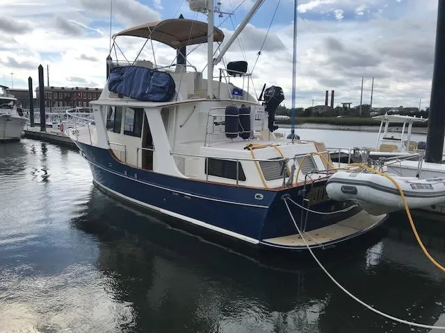 Slide: The Image of Pacific Seacraft 38T Fast Trawler, 2000 model, docked in a marina with inflatable dinghy. - 4