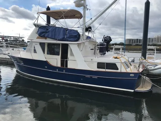 Slide: The Image of 2000 Pacific Seacraft 38T Fast Trawler docked at marina, blue hull, white cabin. - 5