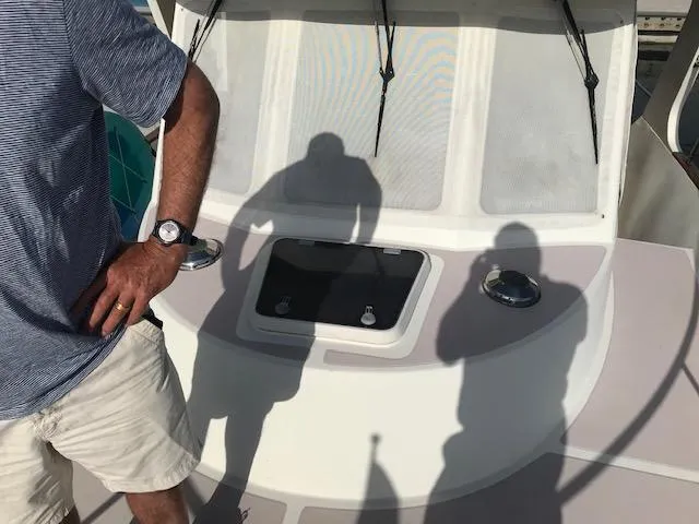 Slide: The Image of 2000 Pacific Seacraft 38T Fast Trawler deck with shadows and person in casual attire. - 9