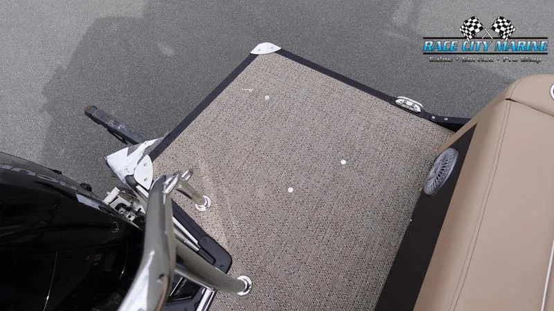 Slide: The Image of 2025 Barletta Cabrio 22UC boat deck with beige seating and Race City Marine logo. - 10