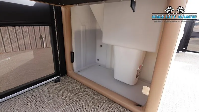 Slide: The Image of 2025 Barletta Cabrio 22UC storage compartment with beige interior and carpeted flooring. - 24