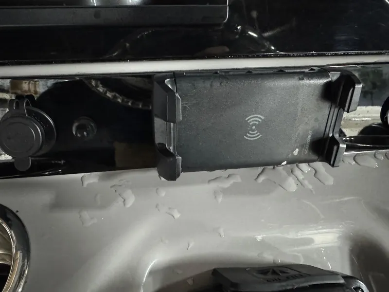 Slide: The Image of Wireless phone charger on 2022 Robalo R230 Center Console boat dashboard. - 13