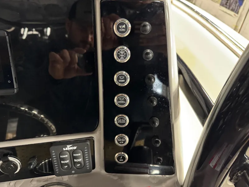 Slide: The Image of 2022 Robalo R230 Center Console dashboard with control buttons and switches. - 15