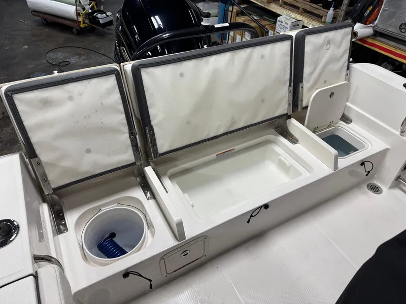 Slide: The Image of 2022 Robalo R230 Center Console boat with open storage compartments and seating. - 17