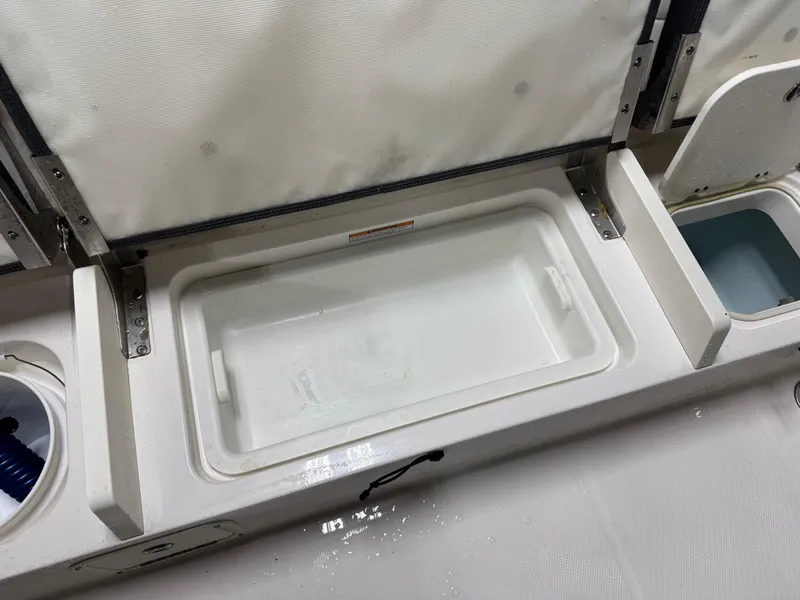 Slide: The Image of Robalo R230 Center Console 2022 boat storage compartments and livewell. - 19