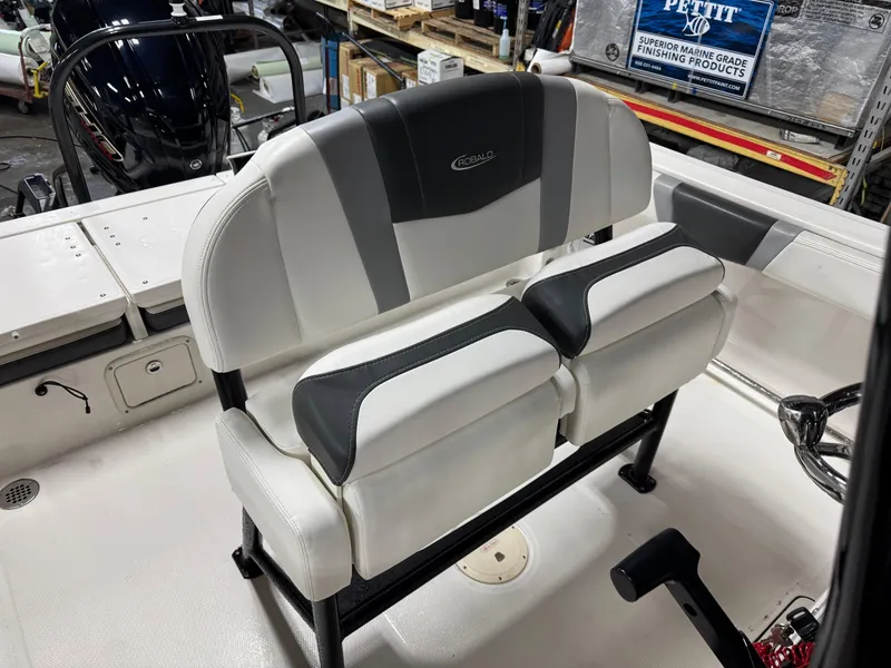 Slide: The Image of 2022 Robalo R230 Center Console boat seating in a showroom. - 21