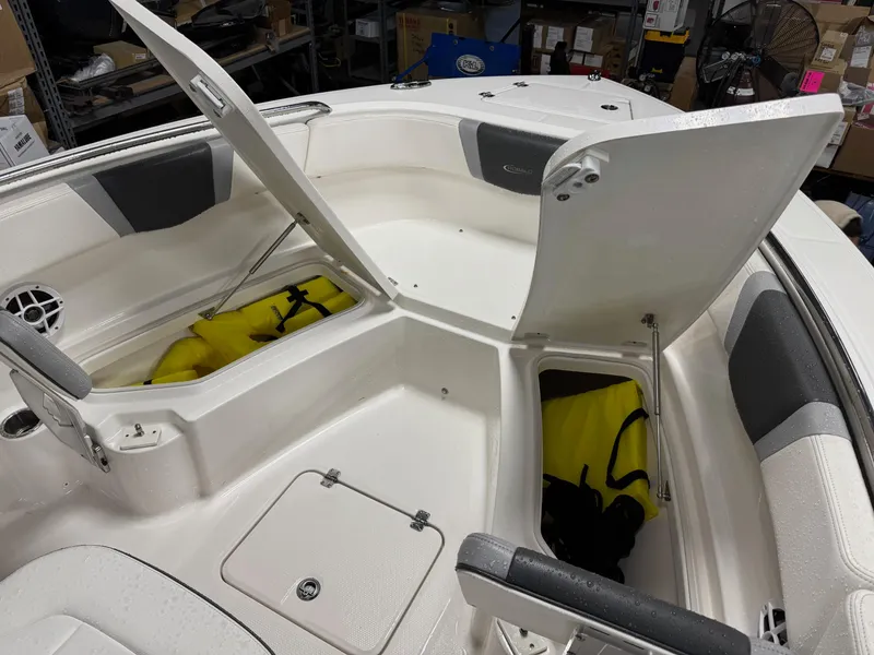 Slide: The Image of 2022 Robalo R230 Center Console boat with open storage compartments. - 23