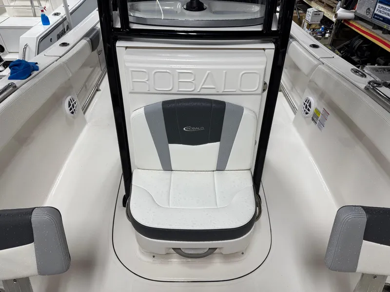 Slide: The Image of 2022 Robalo R230 Center Console boat interior with cushioned seating. - 25
