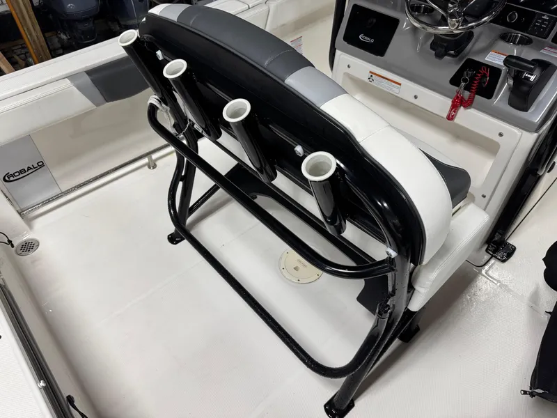 Slide: The Image of 2022 Robalo R230 Center Console boat interior with rod holders and steering console. - 27