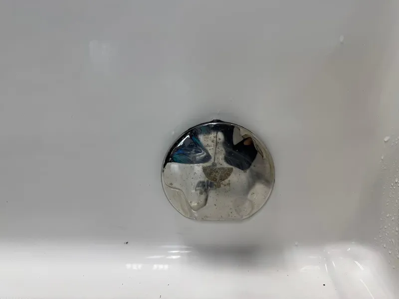 Slide: The Image of Close-up of a drain plug on a 2022 Robalo R230 Center Console boat. - 32