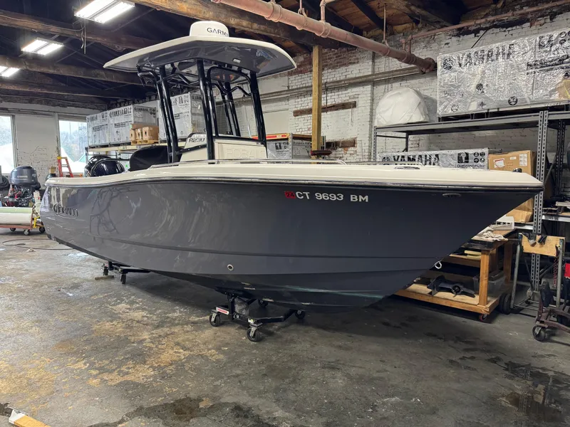Slide: The Image of 2022 Robalo R230 Center Console boat in a workshop setting. - 4