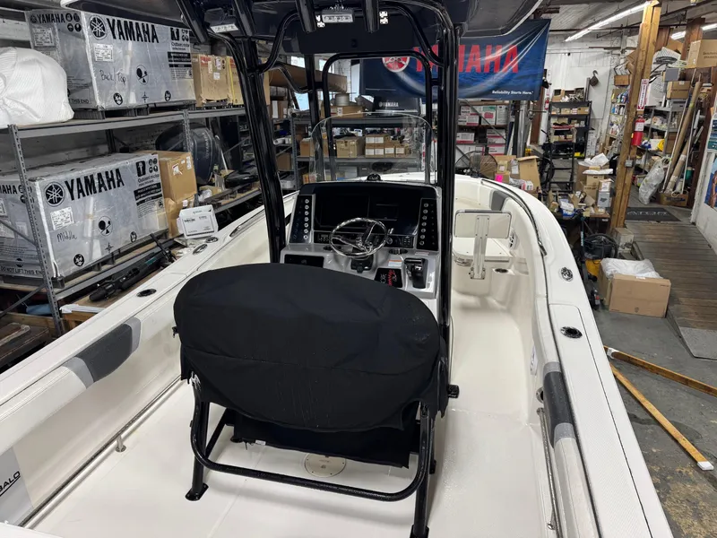 Slide: The Image of 2022 Robalo R230 Center Console boat in a workshop setting. - 5