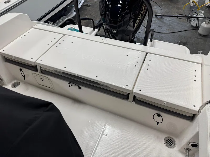 Slide: The Image of 2022 Robalo R230 Center Console boat interior with storage compartments. - 7