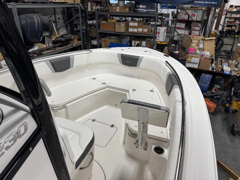 Slide: The Image of 2022 Robalo R230 Center Console boat interior in a storage facility. - 9