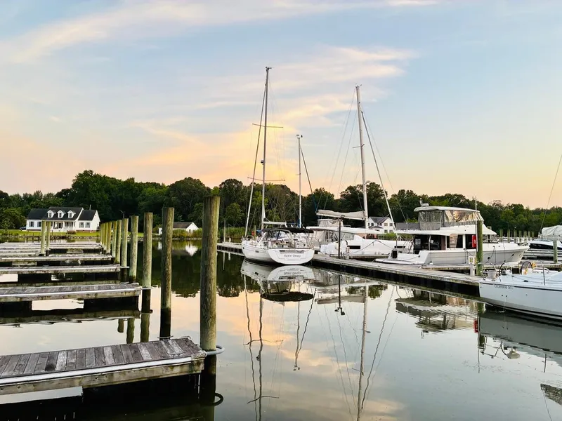 Slide: The Image of Beneteau Oceanis 45 sailboat docked at serene marina, 2017 model, during sunset. - 0