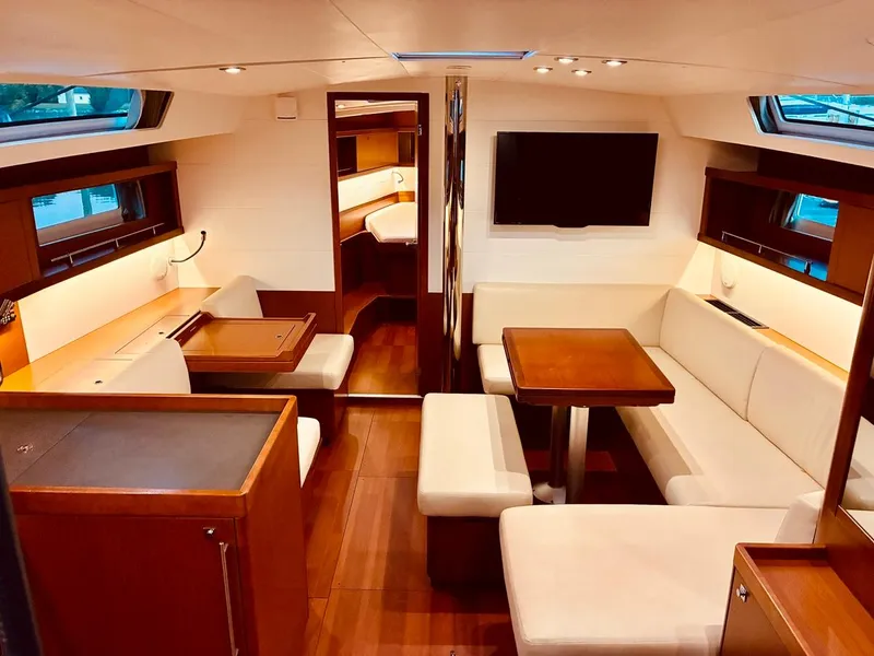Slide: The Image of Interior of 2017 Beneteau Oceanis 45 yacht with elegant seating and wooden finishes. - 10