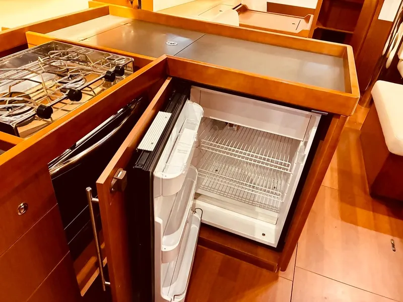 Slide: The Image of 2017 Beneteau Oceanis 45 yacht kitchen with stove and open fridge. - 14