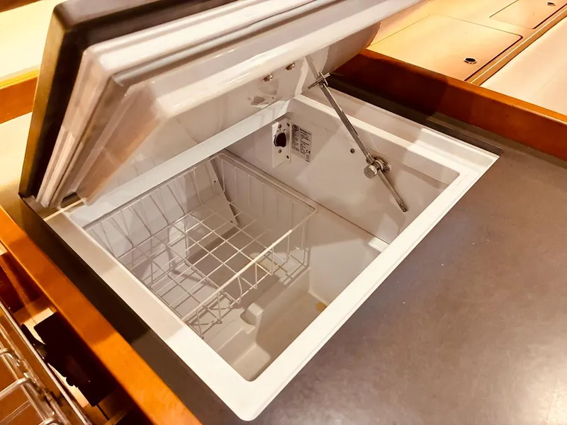 Slide: The Image of Open refrigerator compartment on 2017 Beneteau Oceanis 45 yacht, featuring wire basket storage. - 15