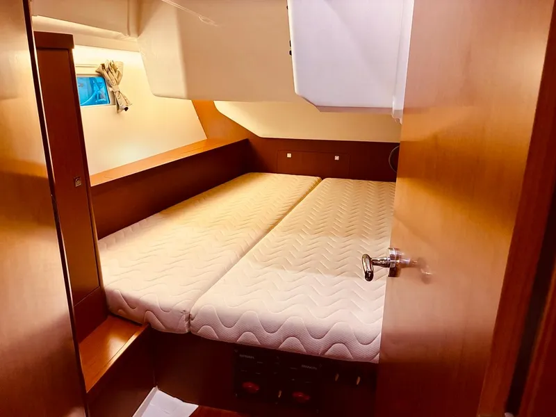 Slide: The Image of Cozy cabin interior of 2017 Beneteau Oceanis 45 sailboat with twin beds and wooden finish. - 16
