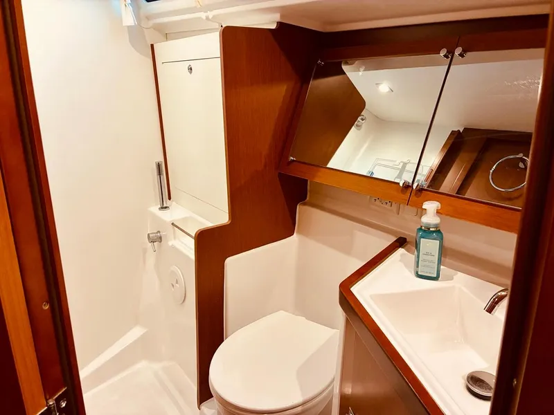 Slide: The Image of 2017 Beneteau Oceanis 45 yacht bathroom with modern fixtures and wooden accents. - 18