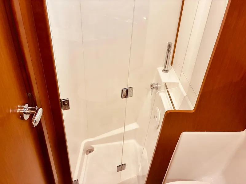 Slide: The Image of Shower area in 2017 Beneteau Oceanis 45 yacht, featuring sleek glass door and modern fixtures. - 19